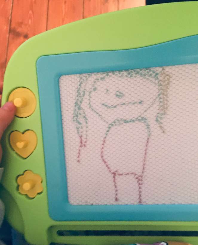 A child's drawing of a person, rendered on a magnetic drawing board