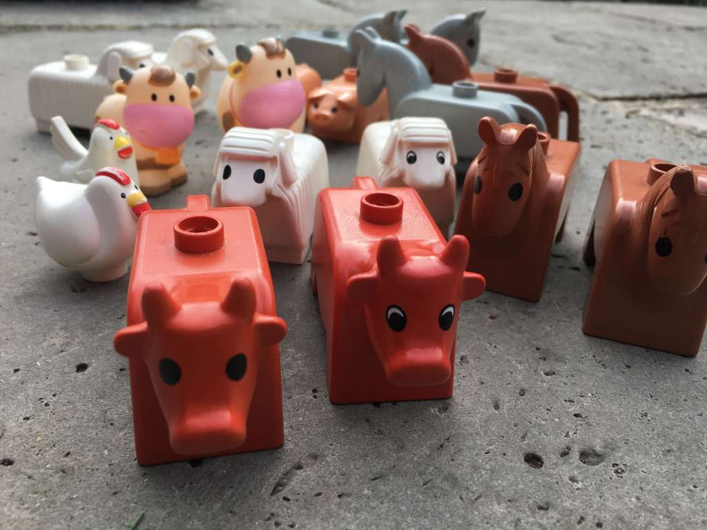 A set of Duplo animal toys, all in pairs: cows, horses, sheep, chickens and pigs