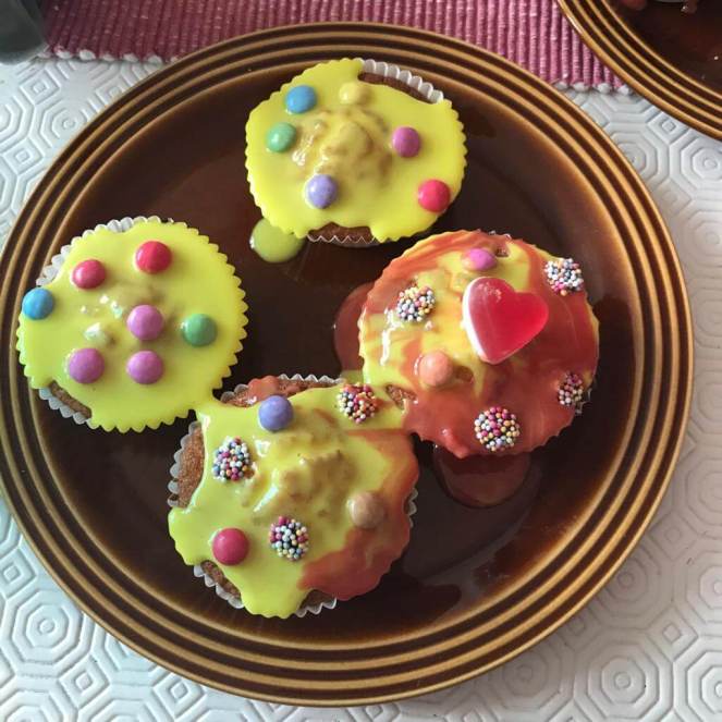A plate of cupcakes baked and decorated by a preschool child