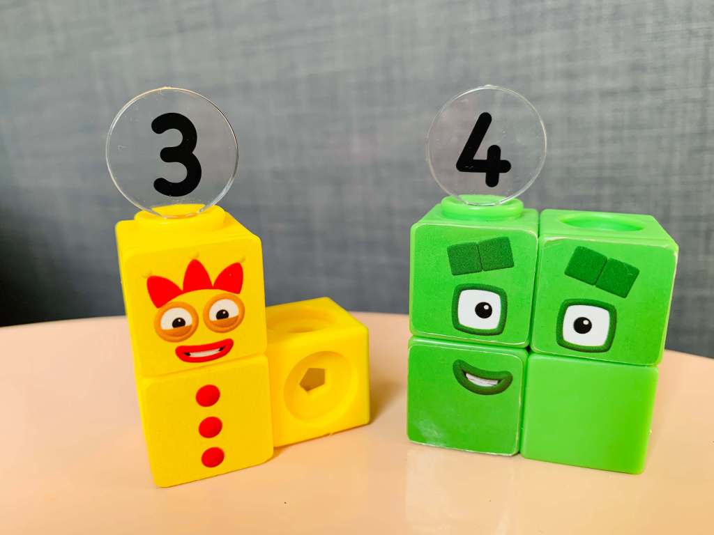 Numberblocks Mathlinks cubes are shown configured for the number three (3) and four (4) to show the distinction between odd and even numbers