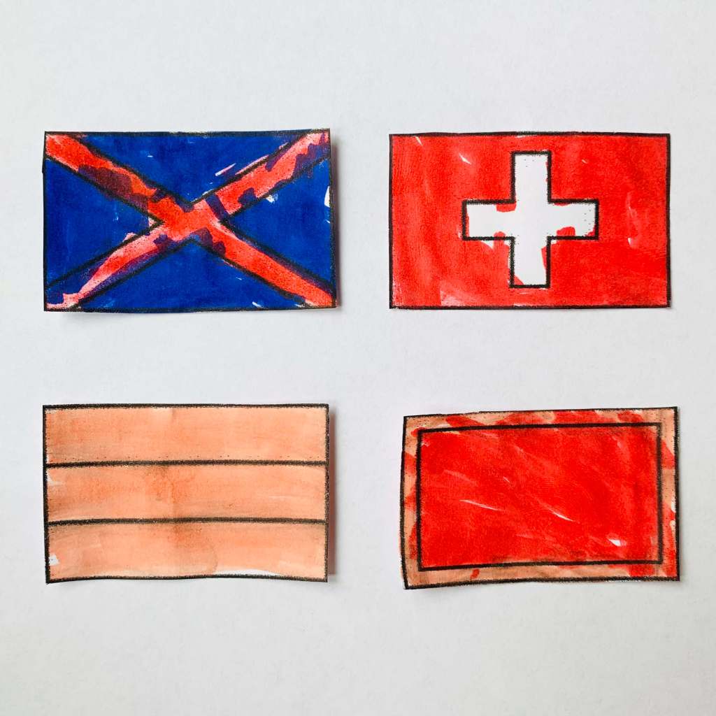 A selection of four flag designs coloured in by a preschool child