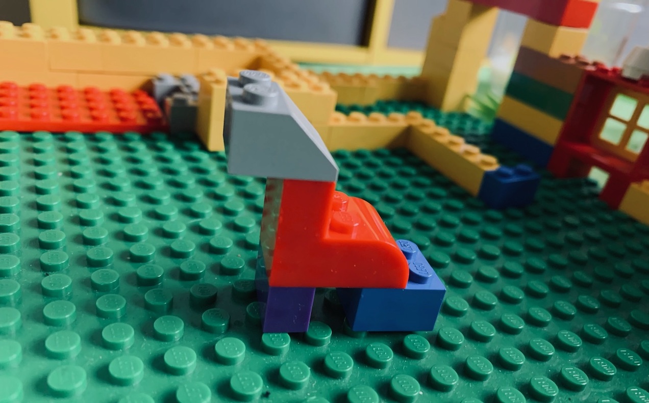 A lego creation – five bricks arranged to make a baby dinosaur