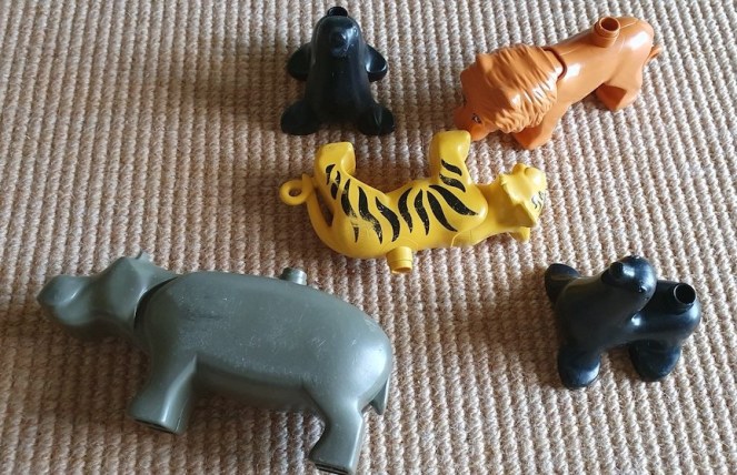 A pile of Duplo animals comprising a lion, a hippo, a tiger and two seals