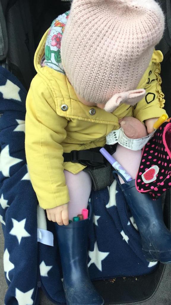 A child stores pens in her wellington boots