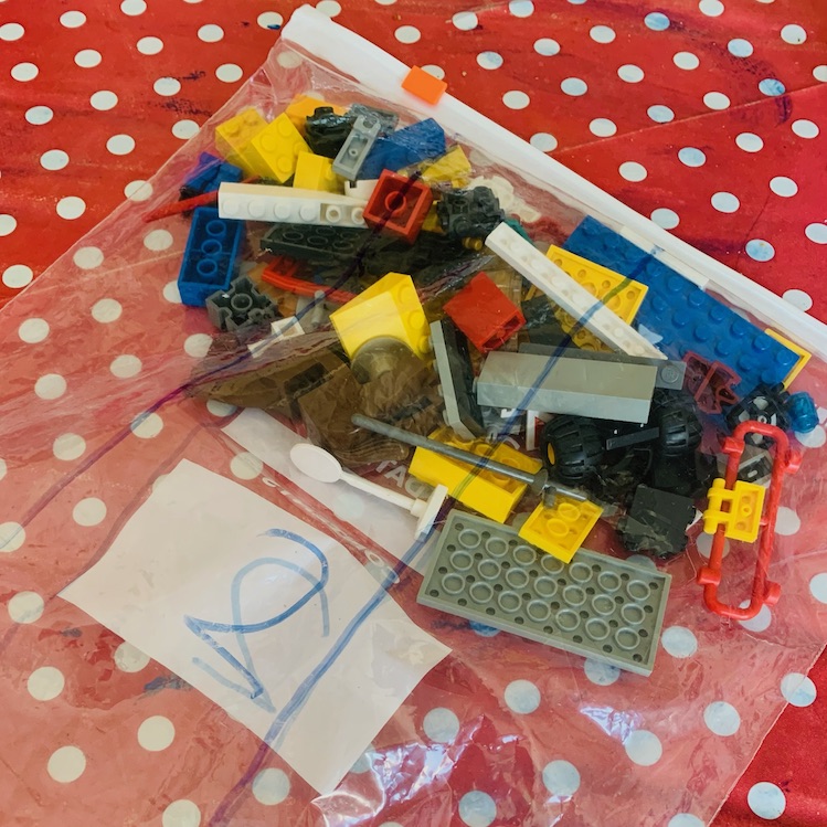 A transparent bag of Lego bricks with a number written on the side to recreate the kind of sealed bag that comes in a brand new Lego construction set